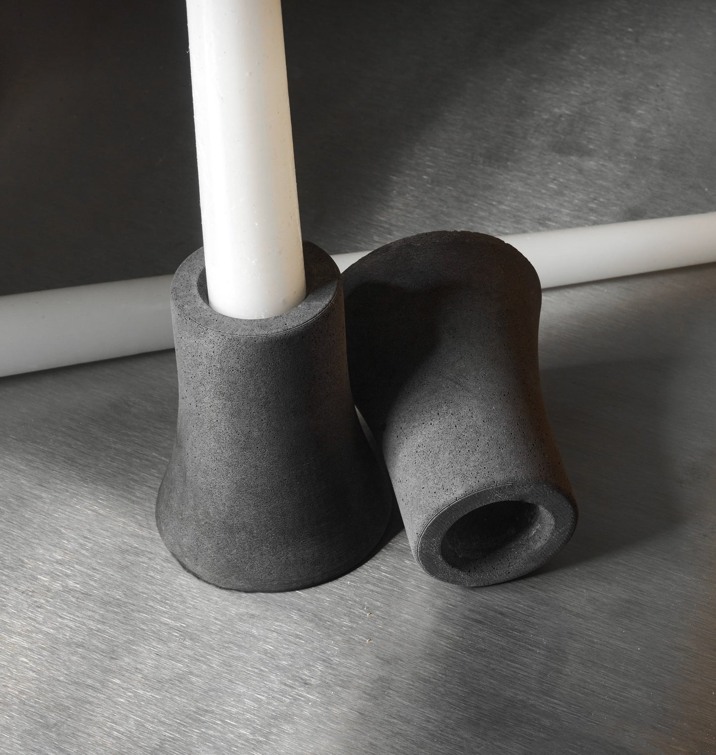Gray candlesticks on stainless steel