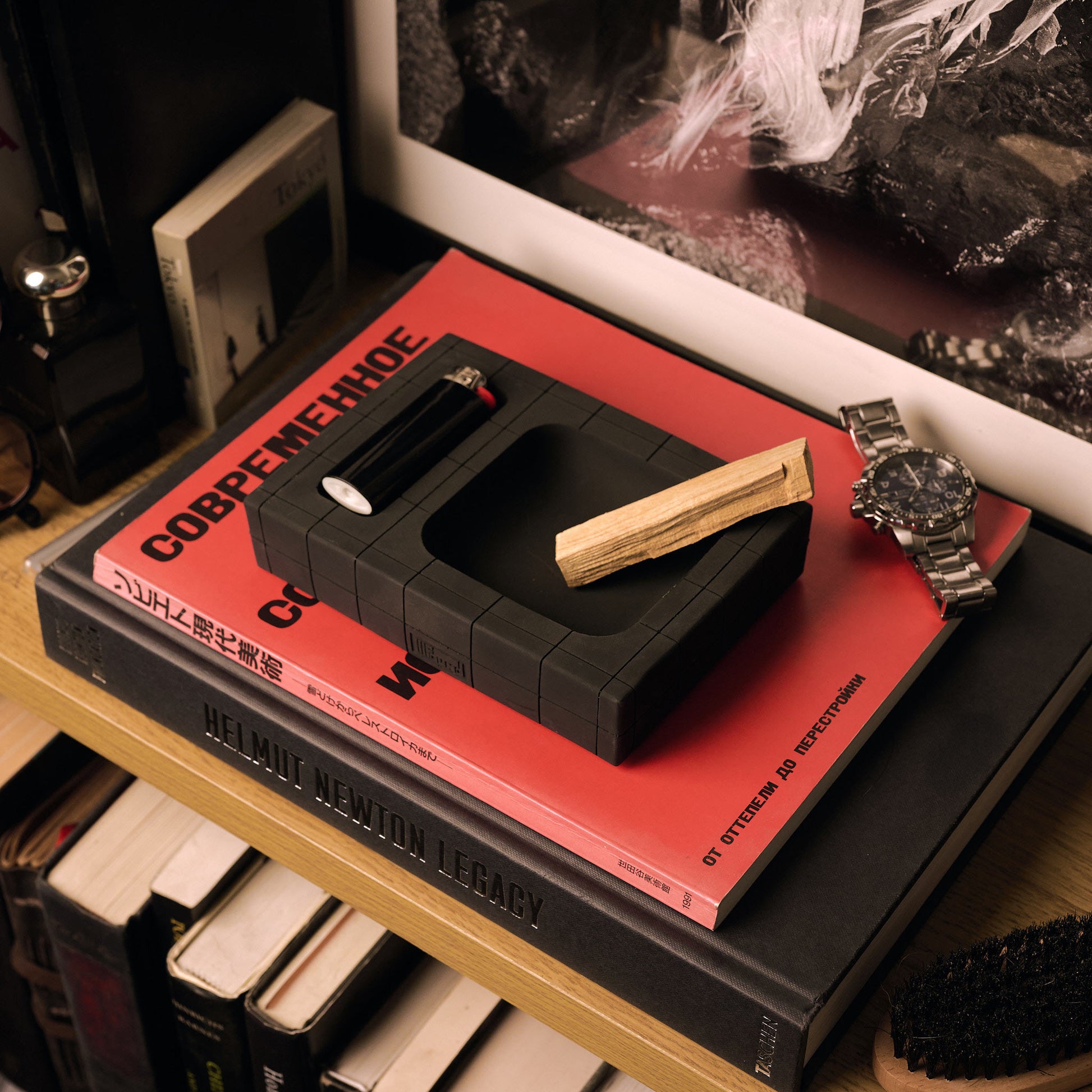 Exhaust Illfound Pool Tray on books and next to a watch and cologne