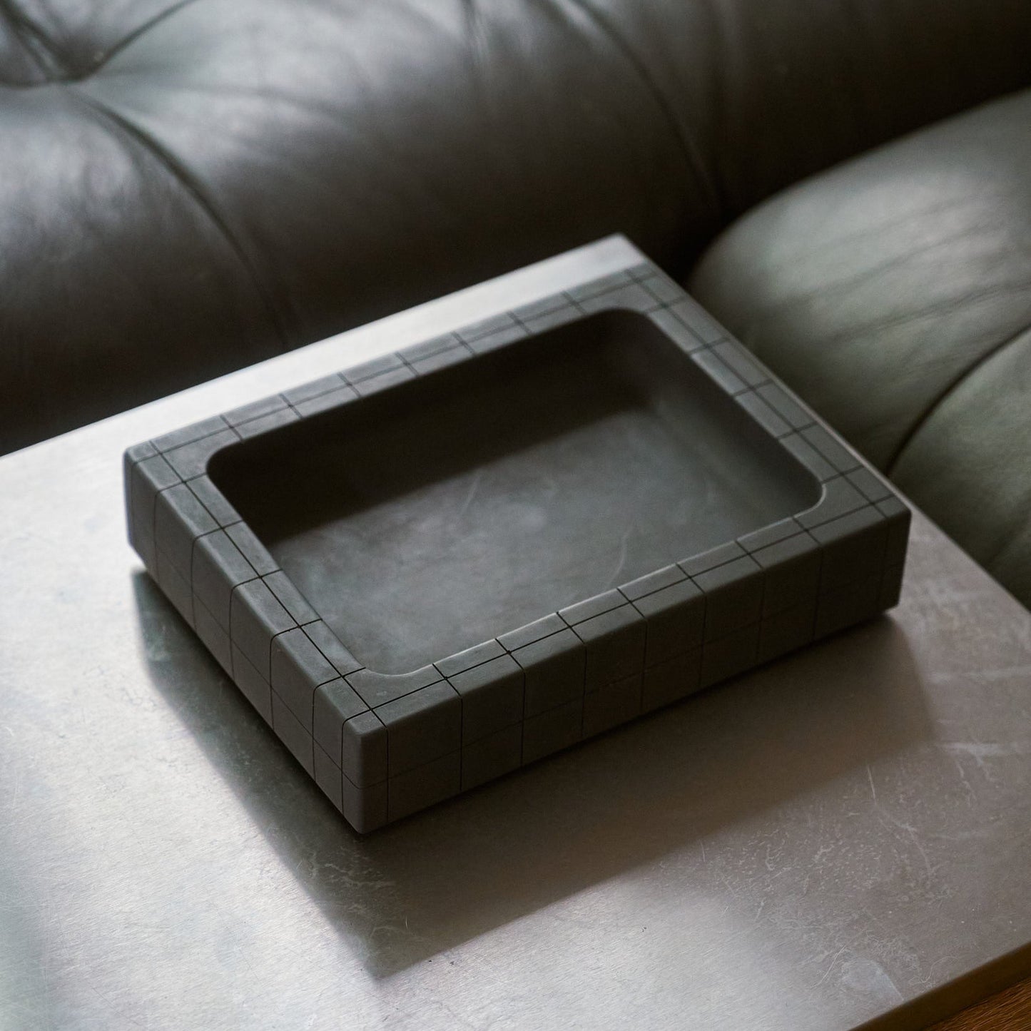 Illfound valet tray on on coffee table next to couch