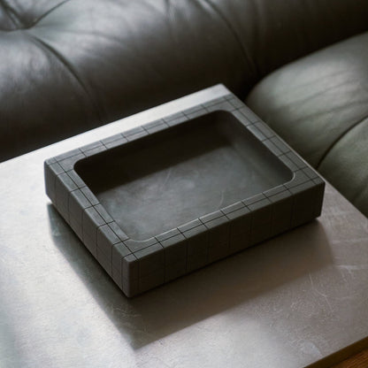 Illfound valet tray on on coffee table next to couch